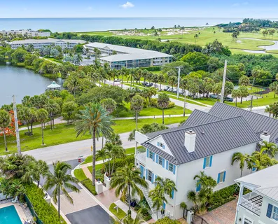 an aerial view of a houses with a lake