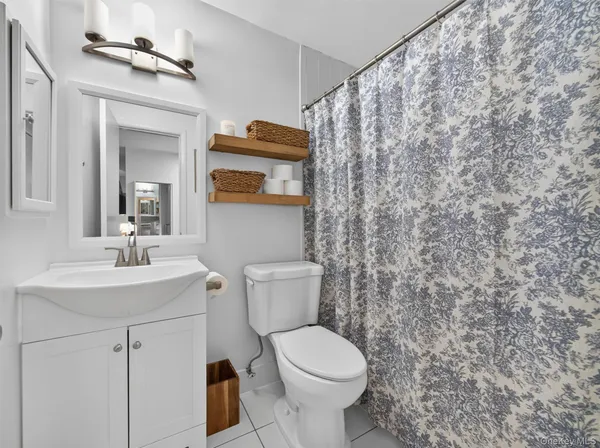 a bathroom with a toilet a sink and a mirror