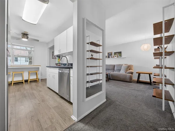 a kitchen with cabinets and chairs