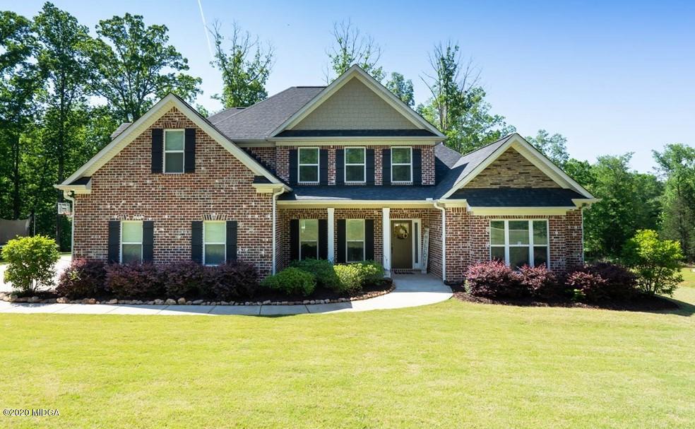 a front view of house with yard and green space