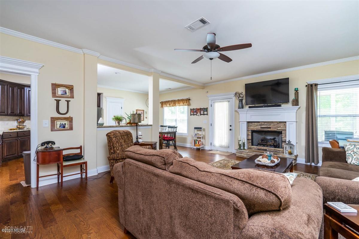 20 Laurel Ridge Forsyth, GA 31029 - Photo 12 of 34 a living room with furniture a flat screen tv and a fireplace