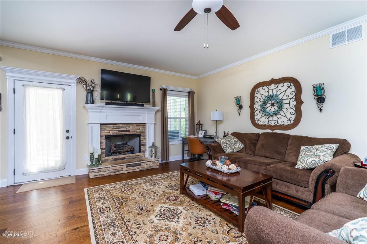 20 Laurel Ridge Forsyth, GA 31029 - Photo 13 of 34 a living room with furniture a flat screen tv and a fireplace