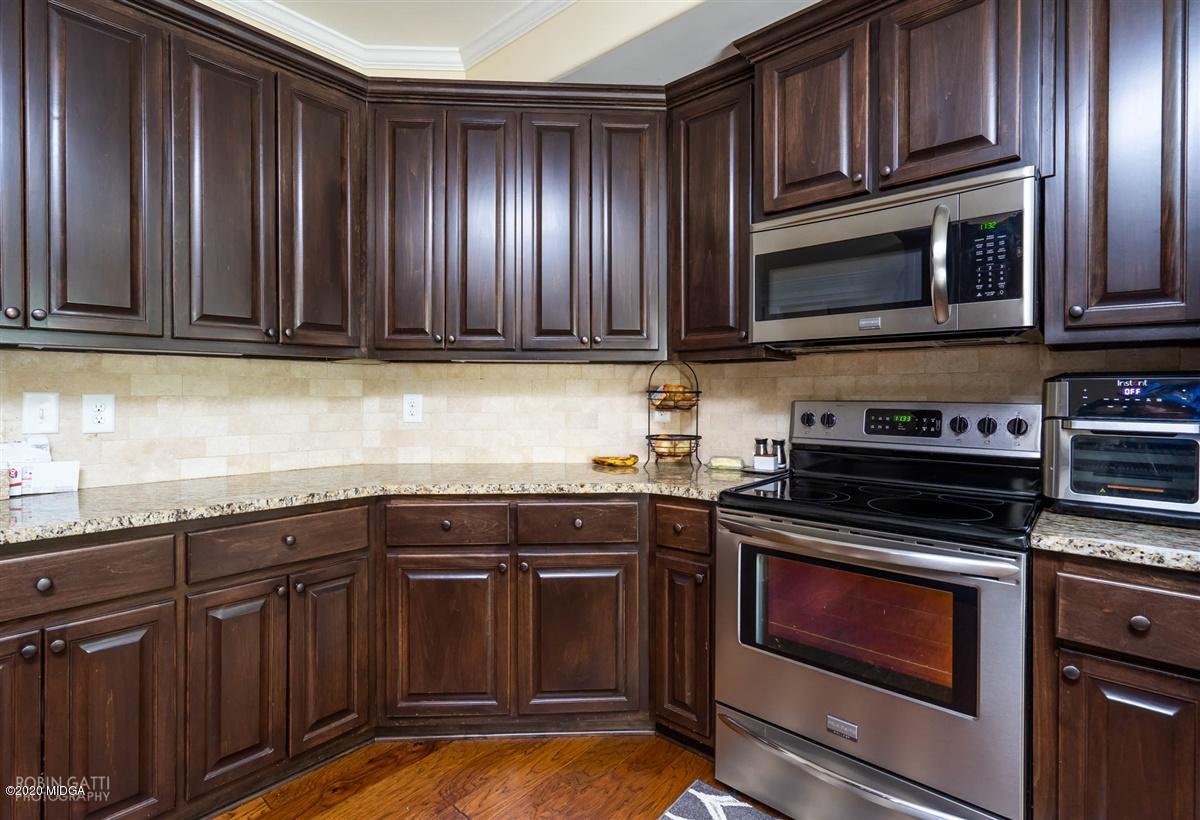 20 Laurel Ridge Forsyth, GA 31029 - Photo 17 of 34 a kitchen with granite countertop wooden cabinets and stainless steel appliances
