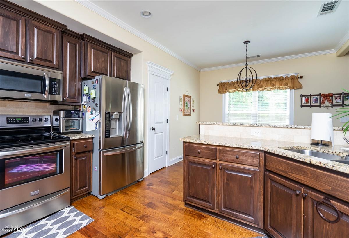 20 Laurel Ridge Forsyth, GA 31029 - Photo 18 of 34 a kitchen with stainless steel appliances granite countertop a refrigerator a stove a sink and a wooden floors