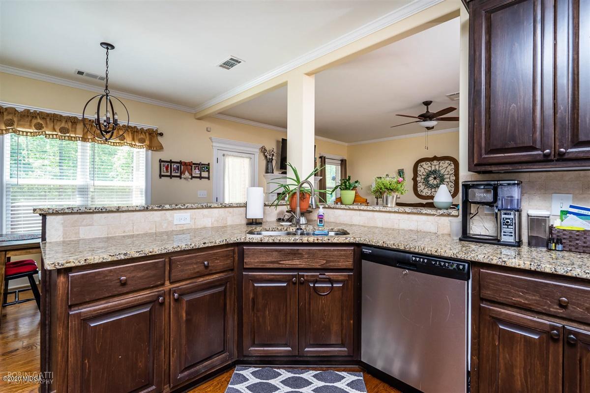 20 Laurel Ridge Forsyth, GA 31029 - Photo 19 of 34 a kitchen with granite countertop stainless steel appliances a sink counter space and a window