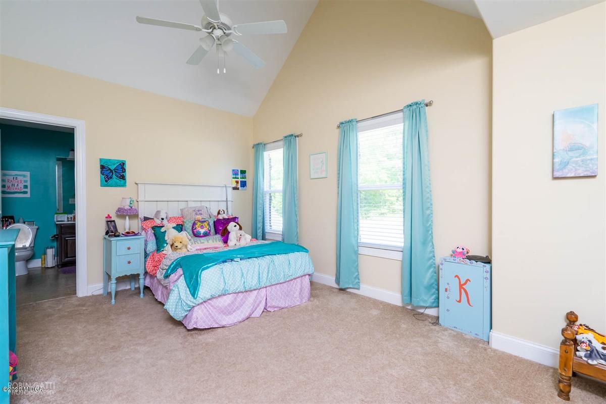 20 Laurel Ridge Forsyth, GA 31029 - Photo 20 of 34 a room with a bed and a chandelier
