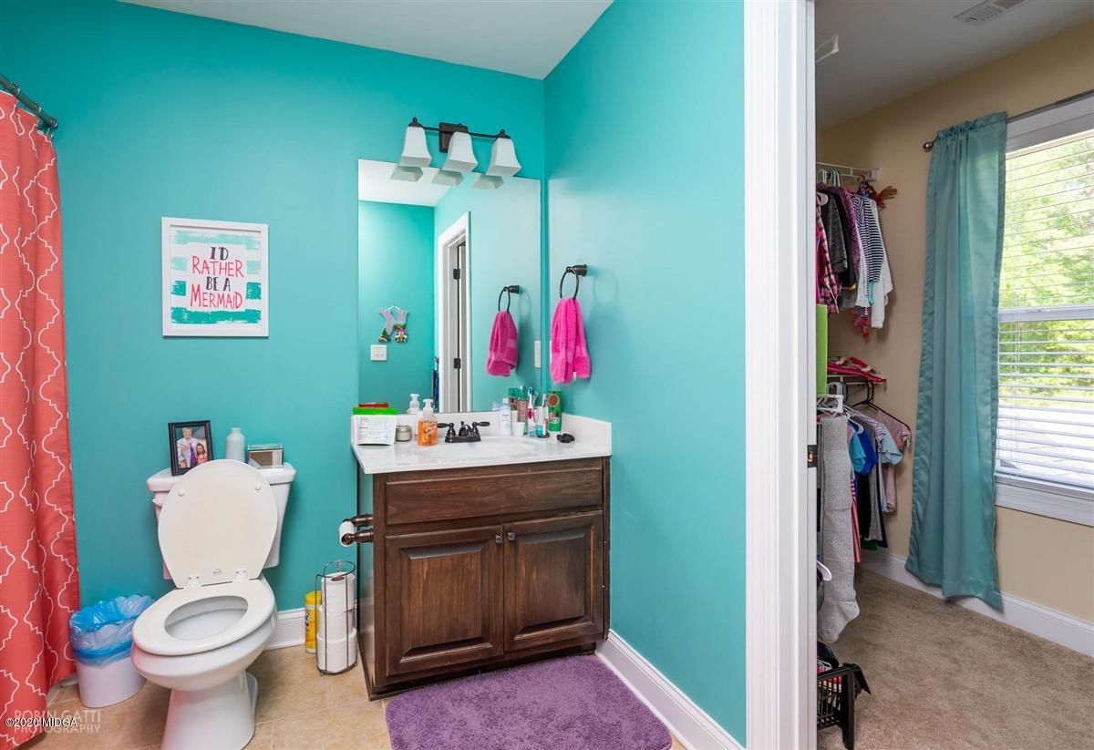 20 Laurel Ridge Forsyth, GA 31029 - Photo 22 of 34 a bathroom with a toilet sink and mirror