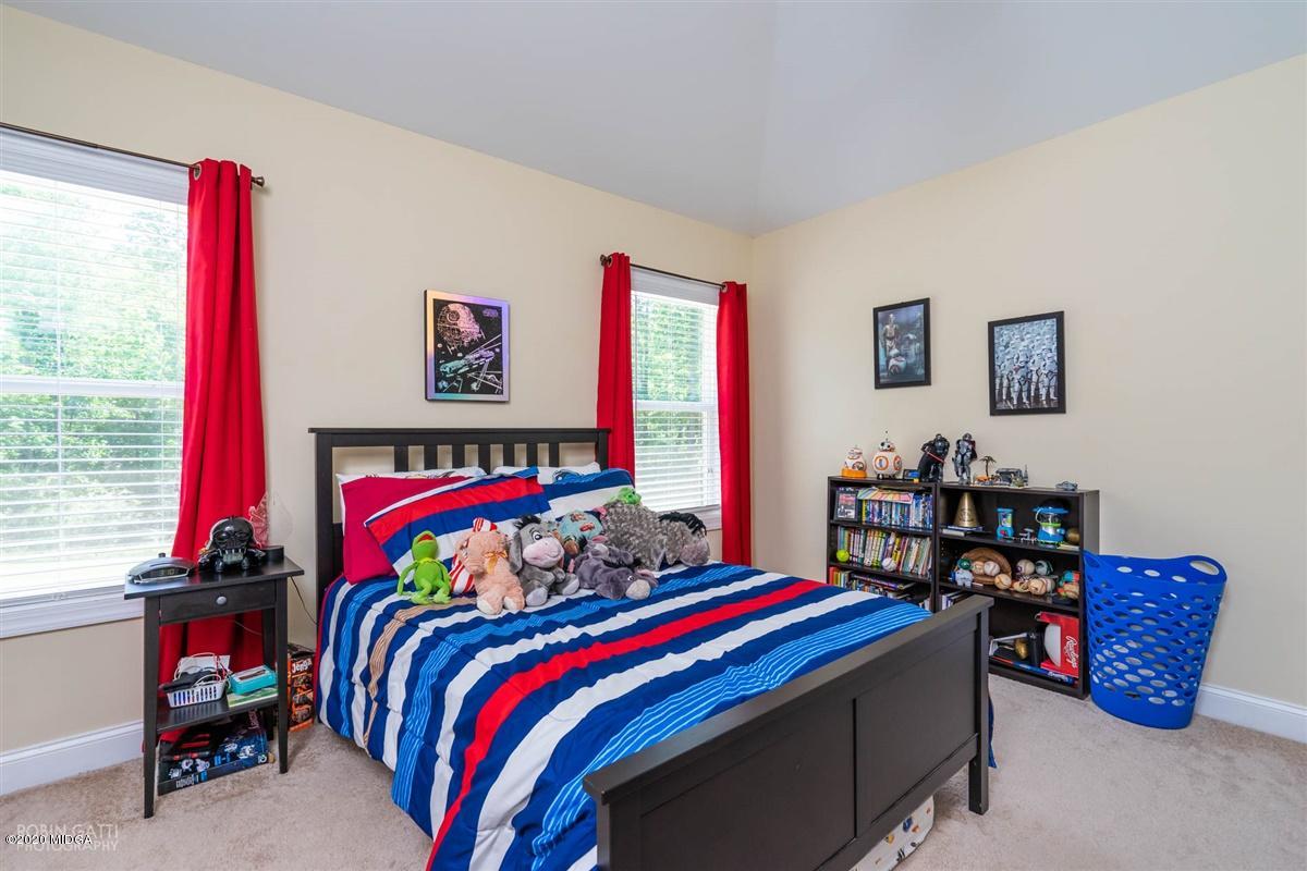 20 Laurel Ridge Forsyth, GA 31029 - Photo 27 of 34 a bed room with a bed and a chair