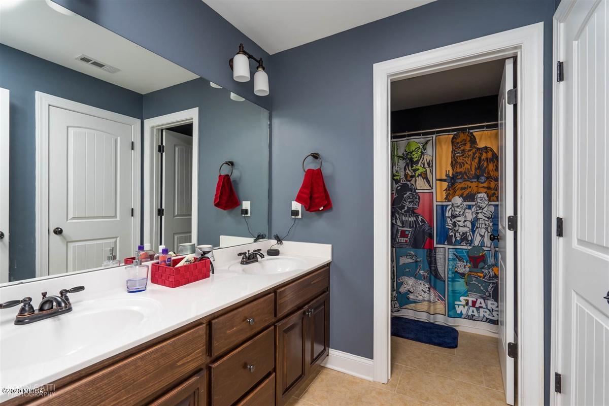 20 Laurel Ridge Forsyth, GA 31029 - Photo 29 of 34 a bathroom with a sink vanity and a mirror