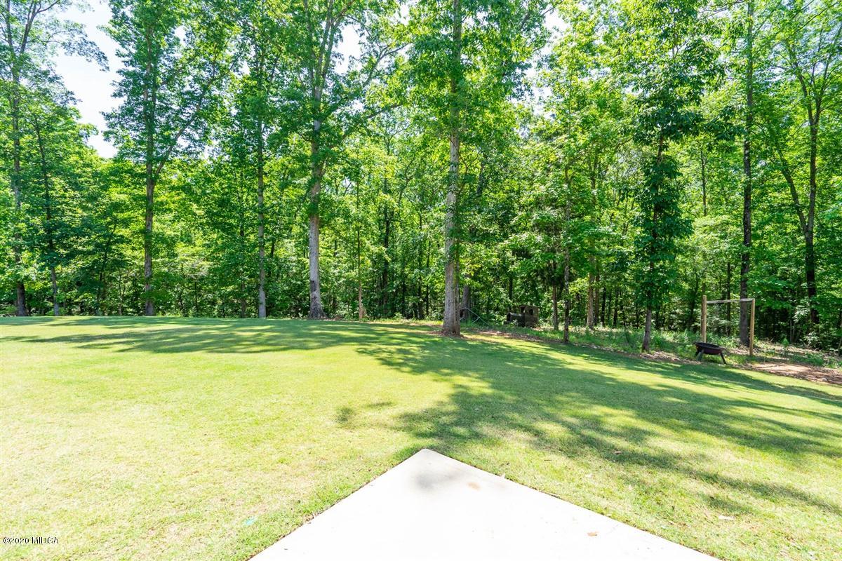 20 Laurel Ridge Forsyth, GA 31029 - Photo 32 of 34 a view of a swimming pool with a yard and large trees