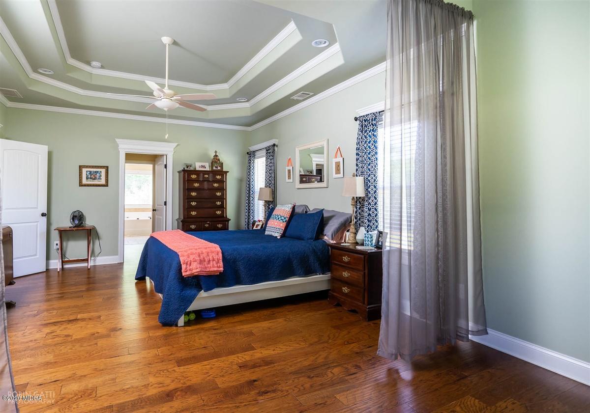 20 Laurel Ridge Forsyth, GA 31029 - Photo 9 of 34 a spacious bedroom with a bed and wooden floor