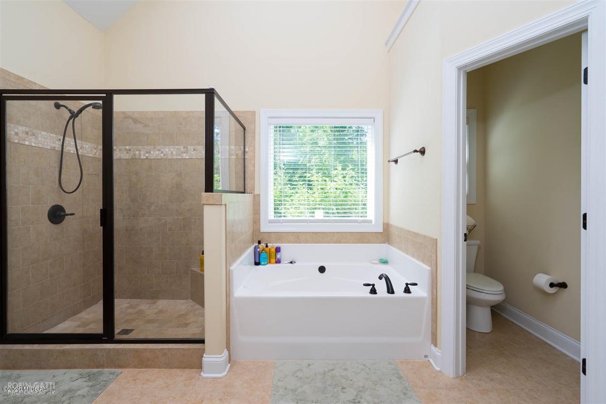 20 Laurel Ridge Forsyth, GA 31029 - Photo 10 of 34 a bathroom with a bathtub and a shower