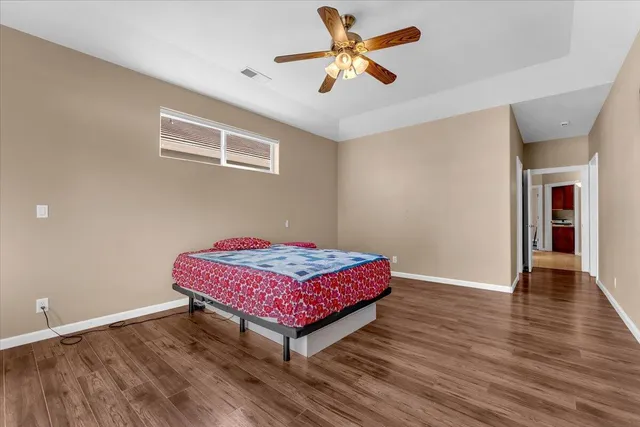 a bathroom with a granite countertop sink a toilet and a mirror