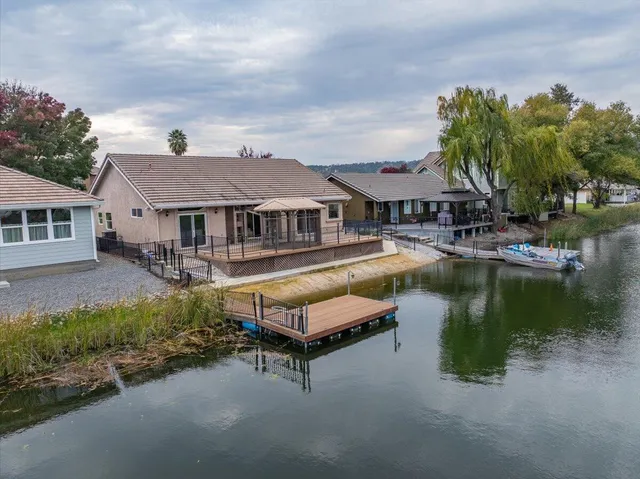 an aerial view of residential houses with outdoor space and river