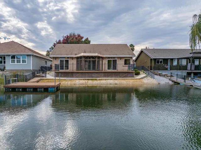 an aerial view of a house with a lake view