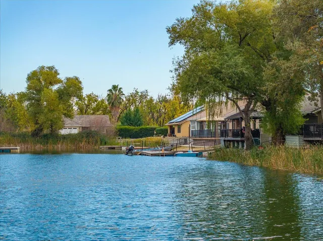 an aerial view of residential house with outdoor space and lake view