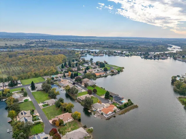 an aerial view of a city with lots of residential buildings and ocean view in back