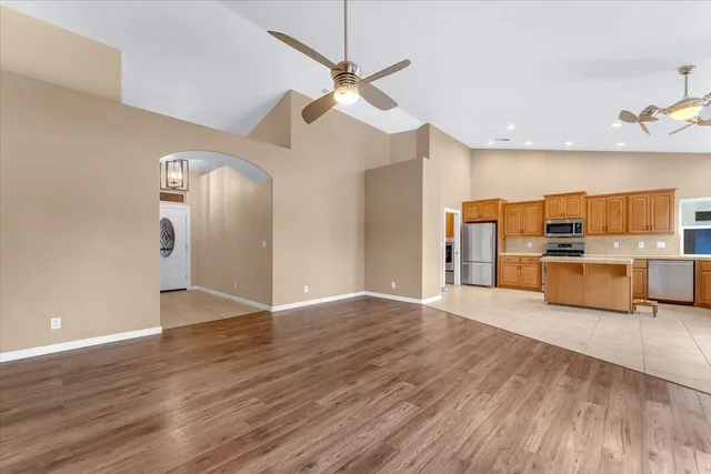 a view of empty room with wooden floor and fireplace
