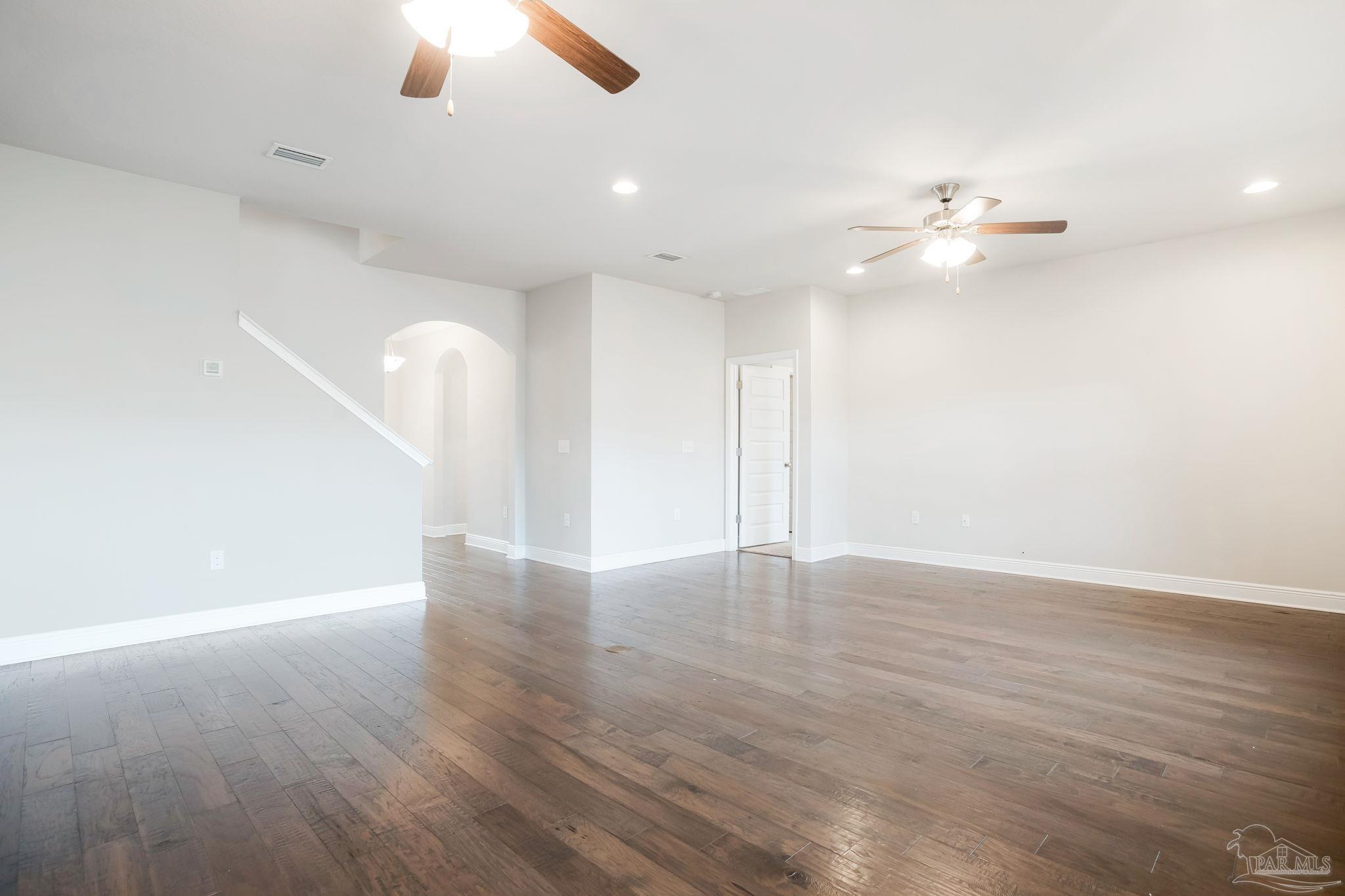 8016 Woodbrook Road Pensacola, FL 32526 - Photo 14 of 52 an empty room with wooden floor fan and window