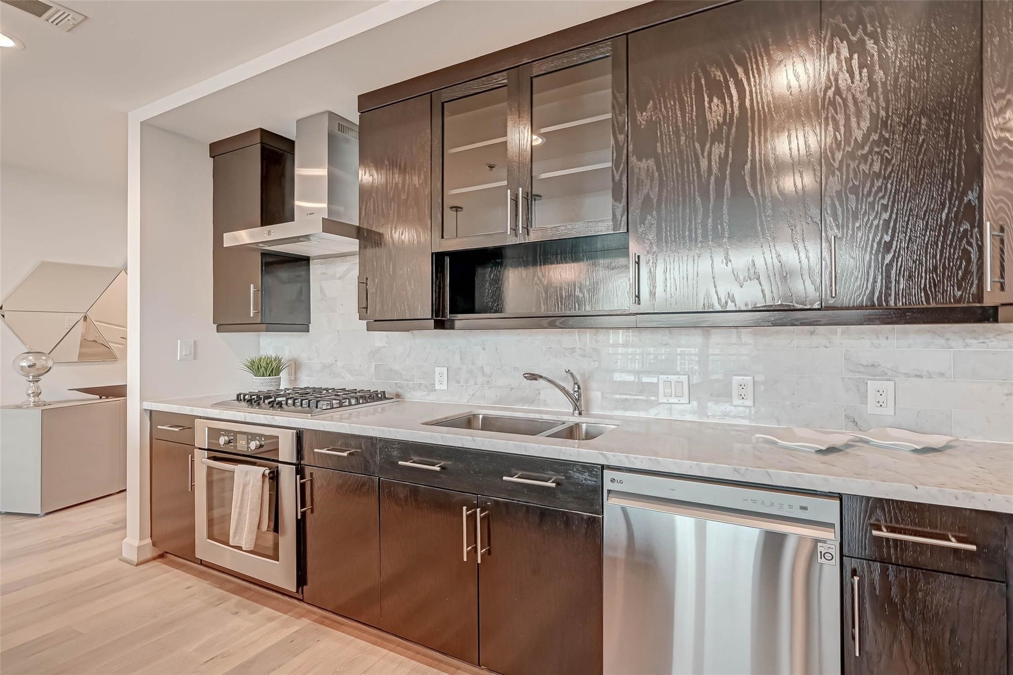 2207 Bancroft Lane, Unit 1202 Houston, TX 77027 - Photo 11 of 47 a kitchen with stainless steel appliances granite countertop a sink stove and cabinets