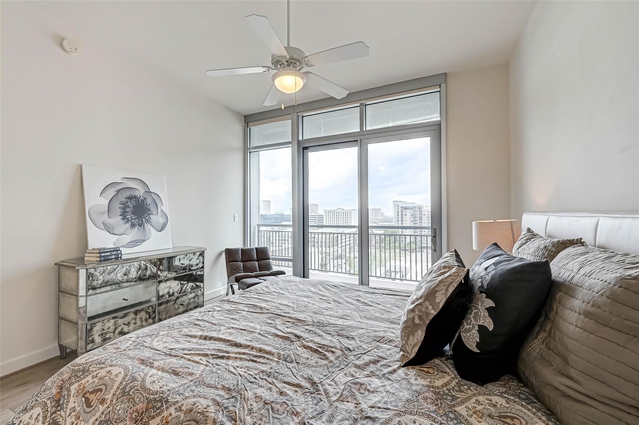 2207 Bancroft Lane, Unit 1202 Houston, TX 77027 - Photo 13 of 47 a bedroom with a bed a table and chair