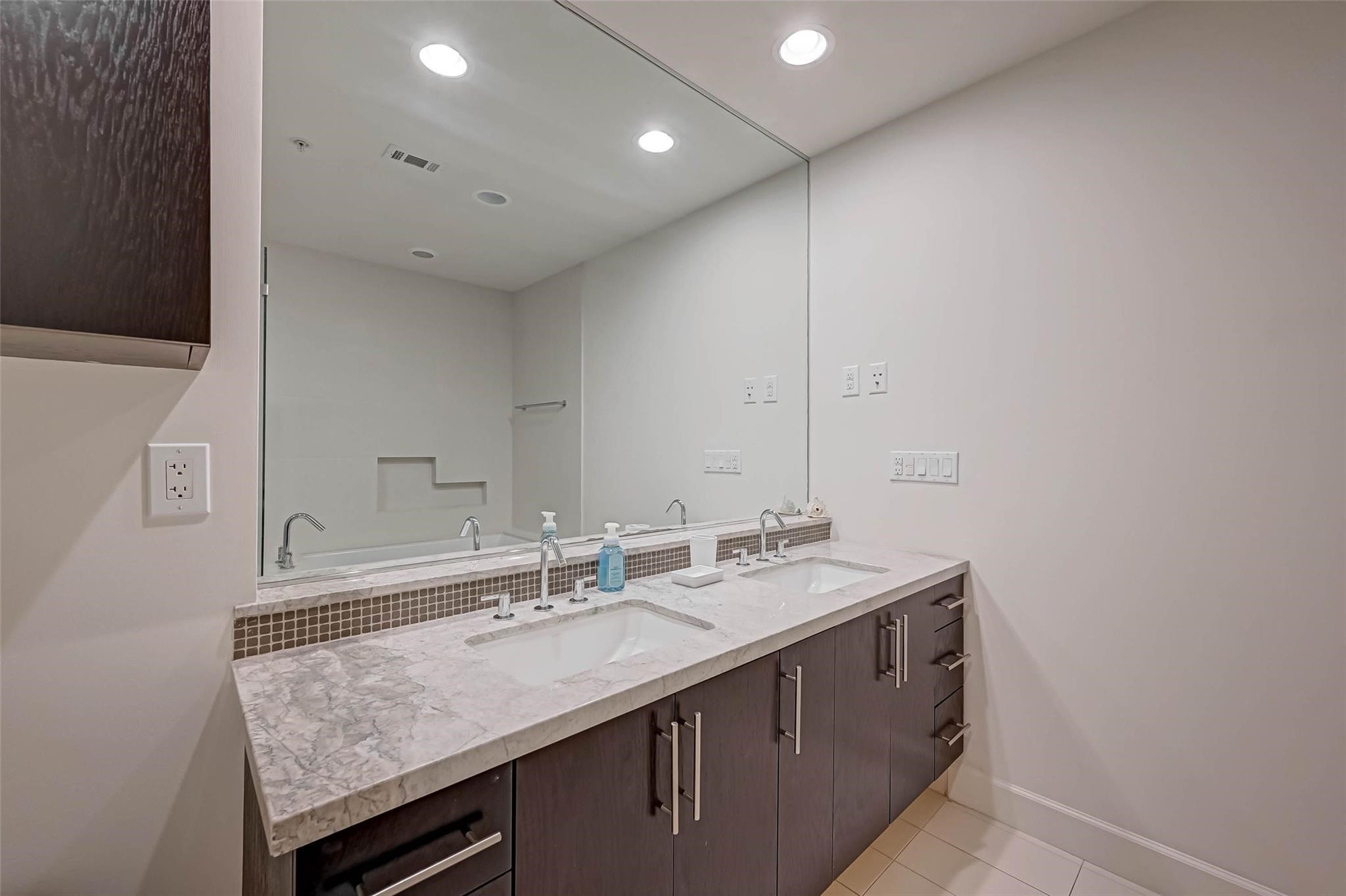 2207 Bancroft Lane, Unit 1202 Houston, TX 77027 - Photo 17 of 47 a bathroom with a sink and a mirror