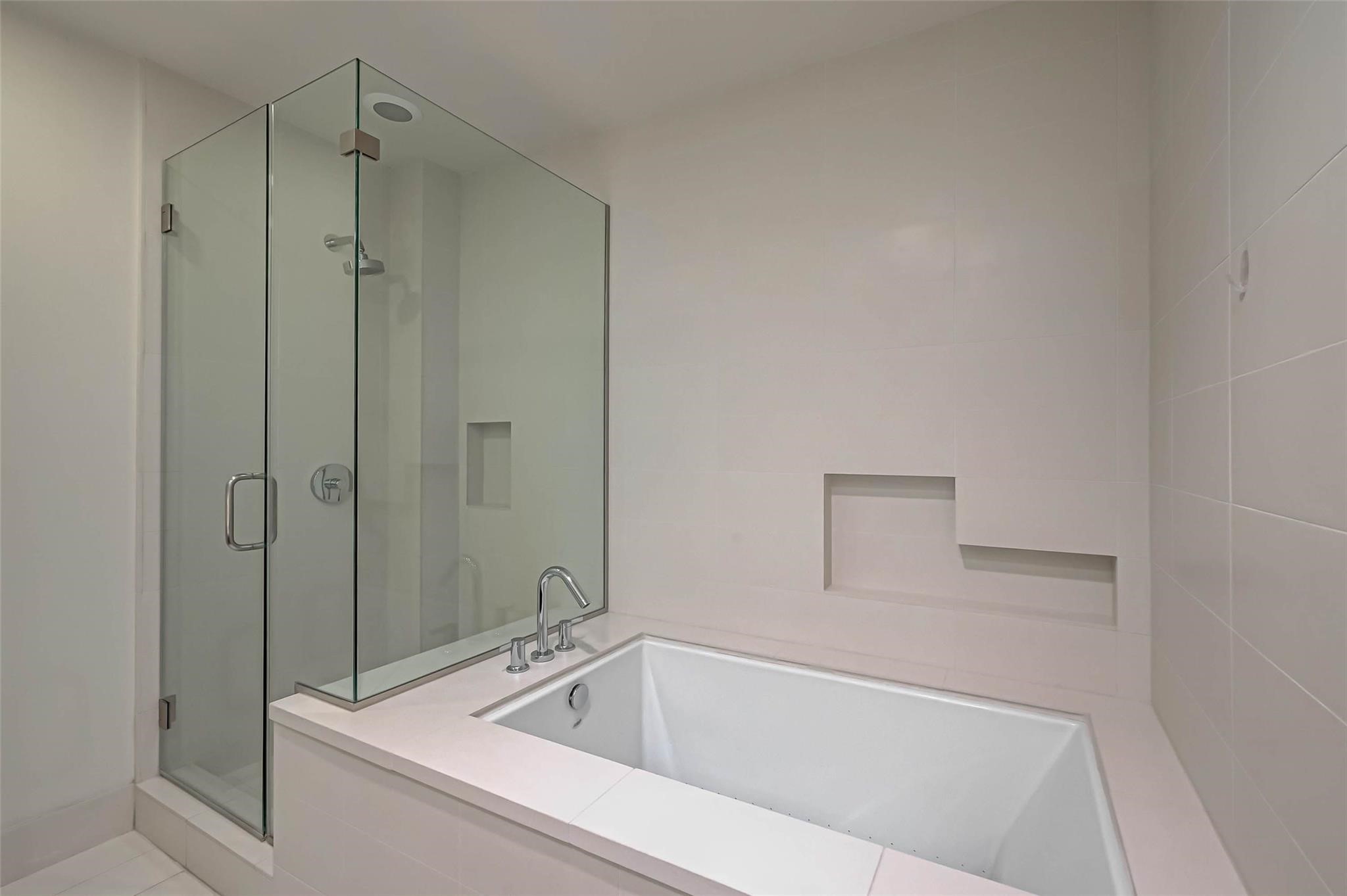 2207 Bancroft Lane, Unit 1202 Houston, TX 77027 - Photo 18 of 47 a white bath tub sitting next to a shower