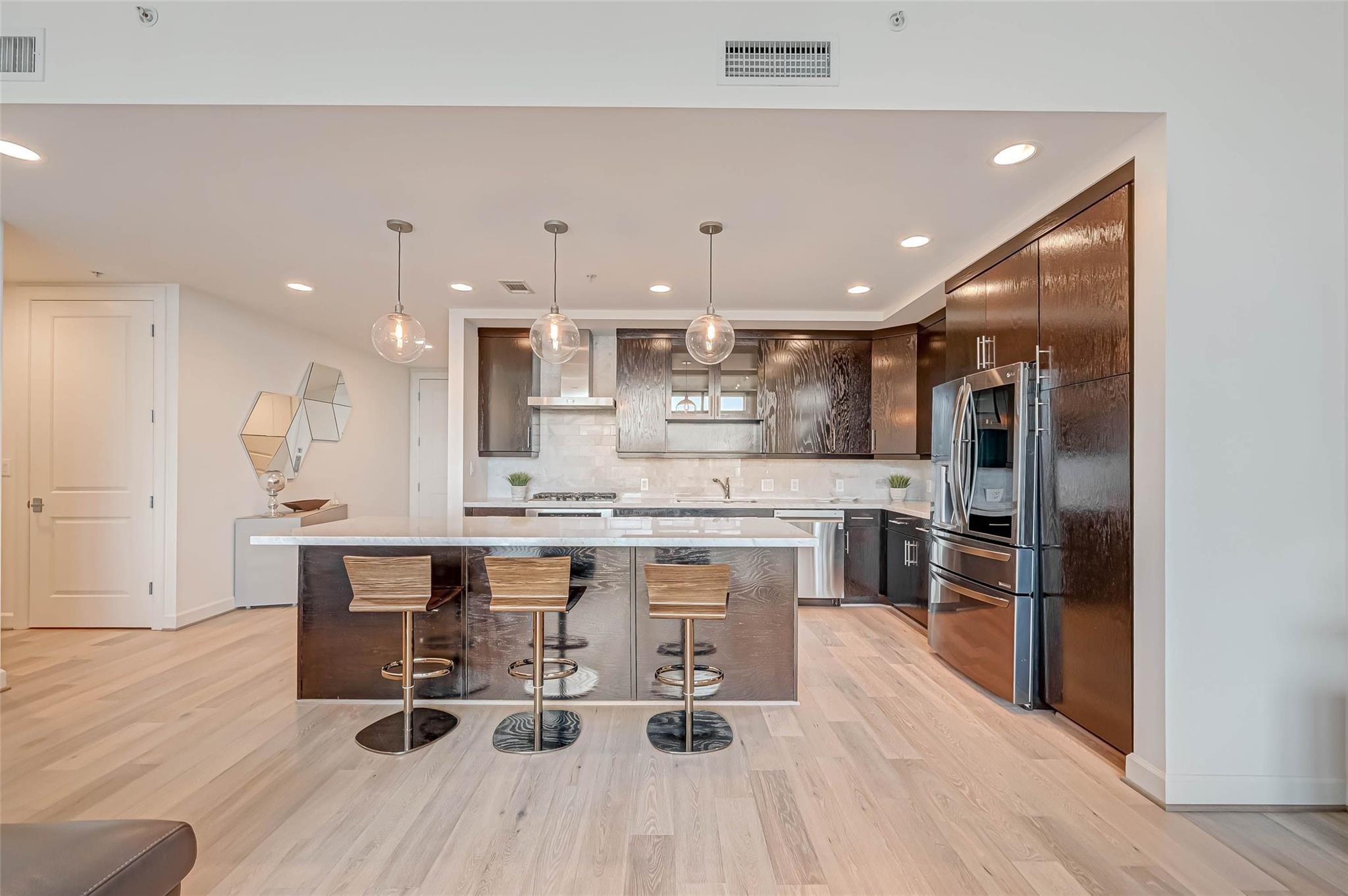 2207 Bancroft Lane, Unit 1202 Houston, TX 77027 - Photo 2 of 47 a large kitchen with a table and chairs in it