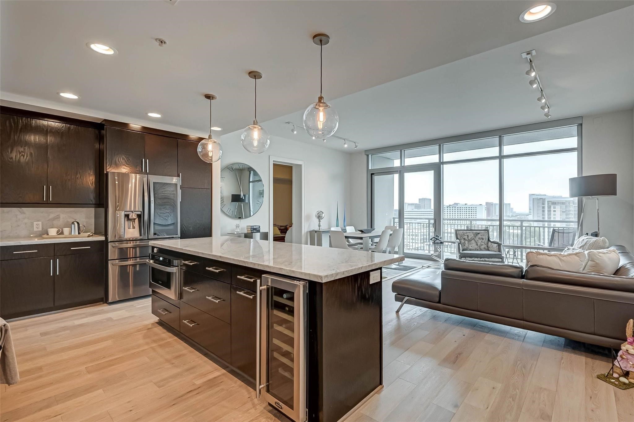 2207 Bancroft Lane, Unit 1202 Houston, TX 77027 - Photo 6 of 47 a large kitchen with kitchen island a large island in the center and stainless steel appliances