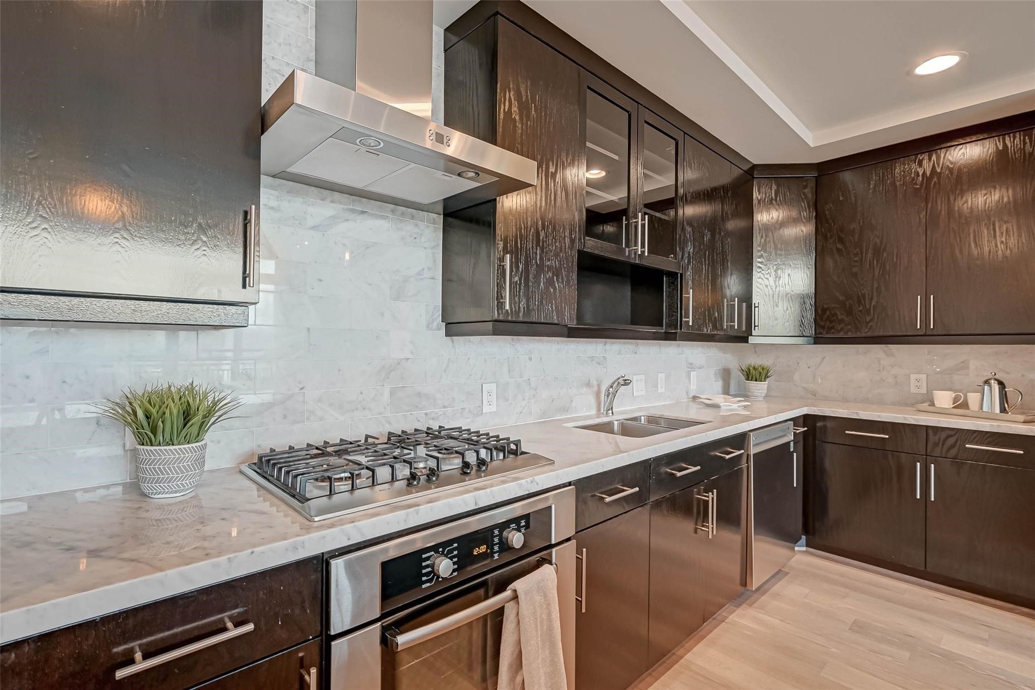 2207 Bancroft Lane, Unit 1202 Houston, TX 77027 - Photo 7 of 47 a kitchen with stainless steel appliances granite countertop a sink stove and cabinets