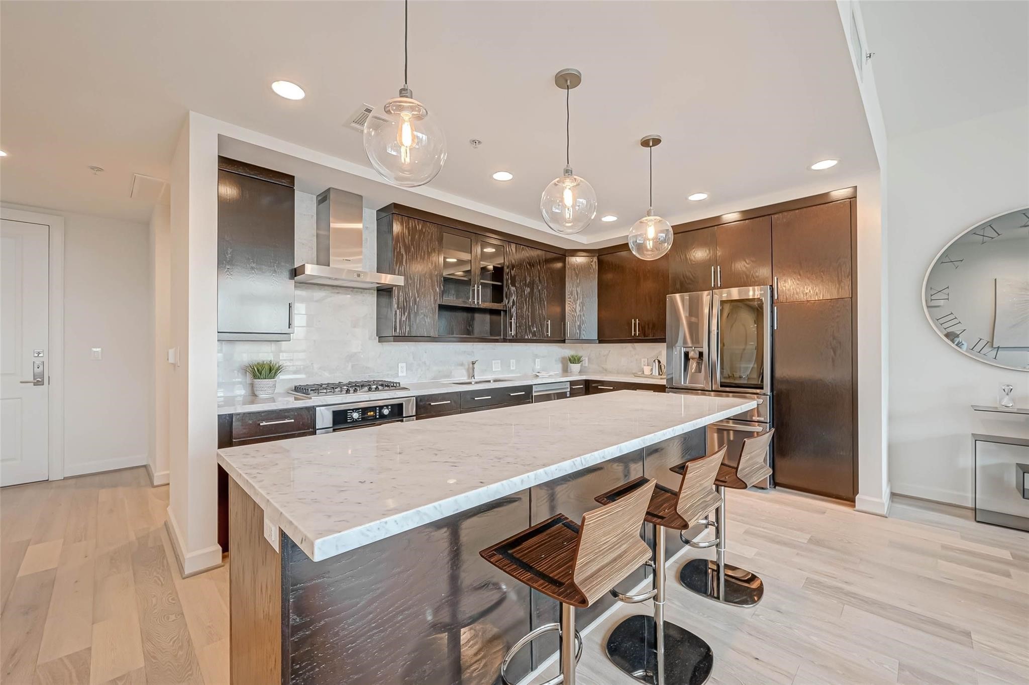 2207 Bancroft Lane, Unit 1202 Houston, TX 77027 - Photo 8 of 47 a large kitchen with a table and chairs