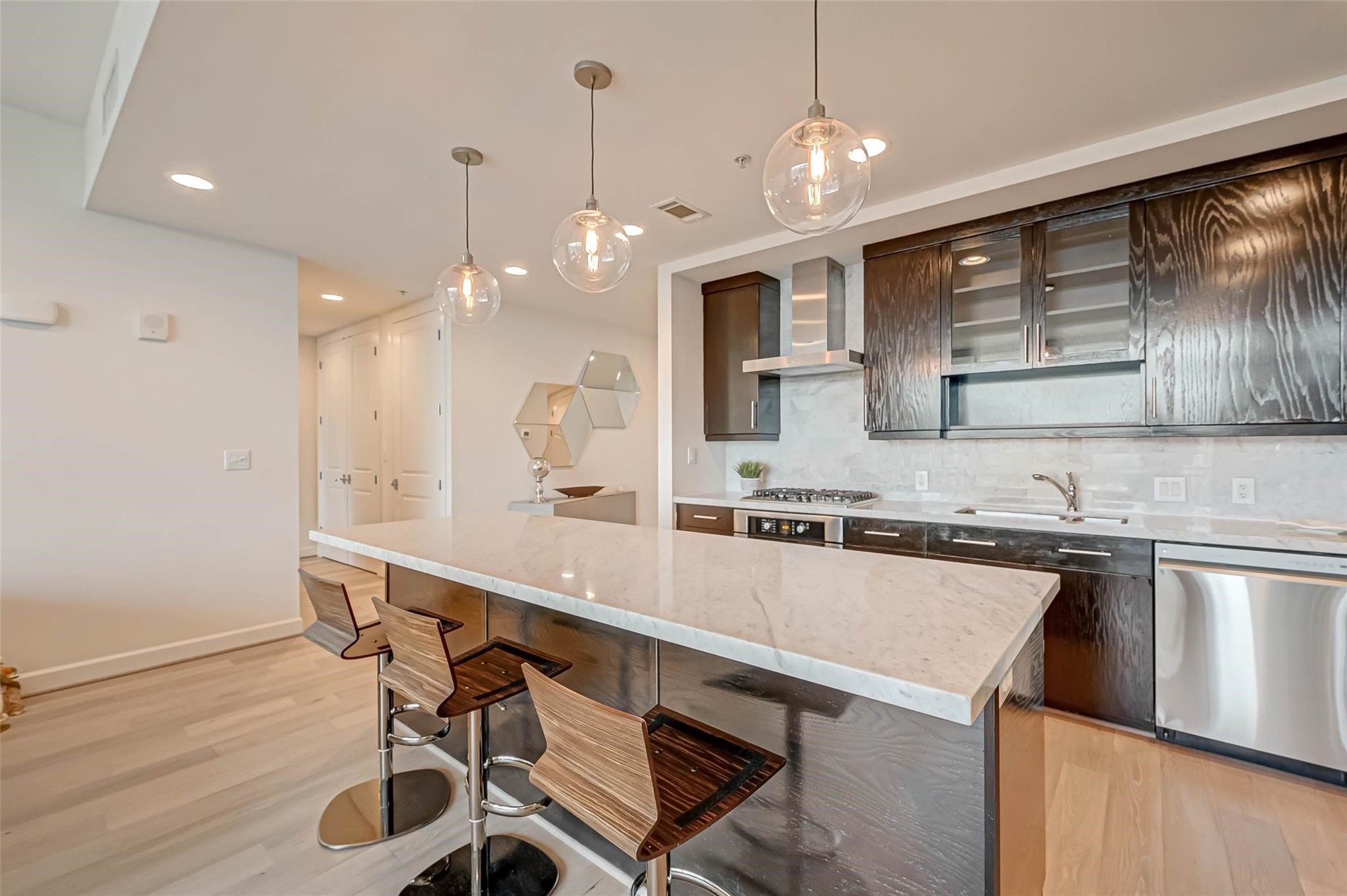 2207 Bancroft Lane, Unit 1202 Houston, TX 77027 - Photo 10 of 47 a large kitchen with a table and chairs in it