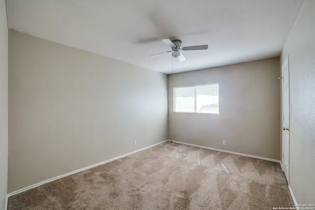 a view of room with a ceiling fan and window