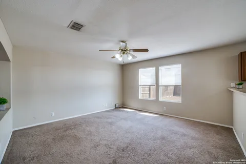 a view of a livingroom with a ceiling fan and window