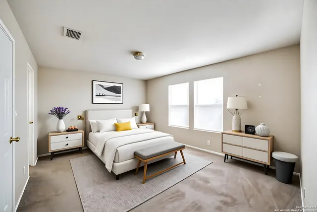 a spacious bedroom with a bed and a large window