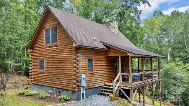 a view of a house with a yard and wooden fence