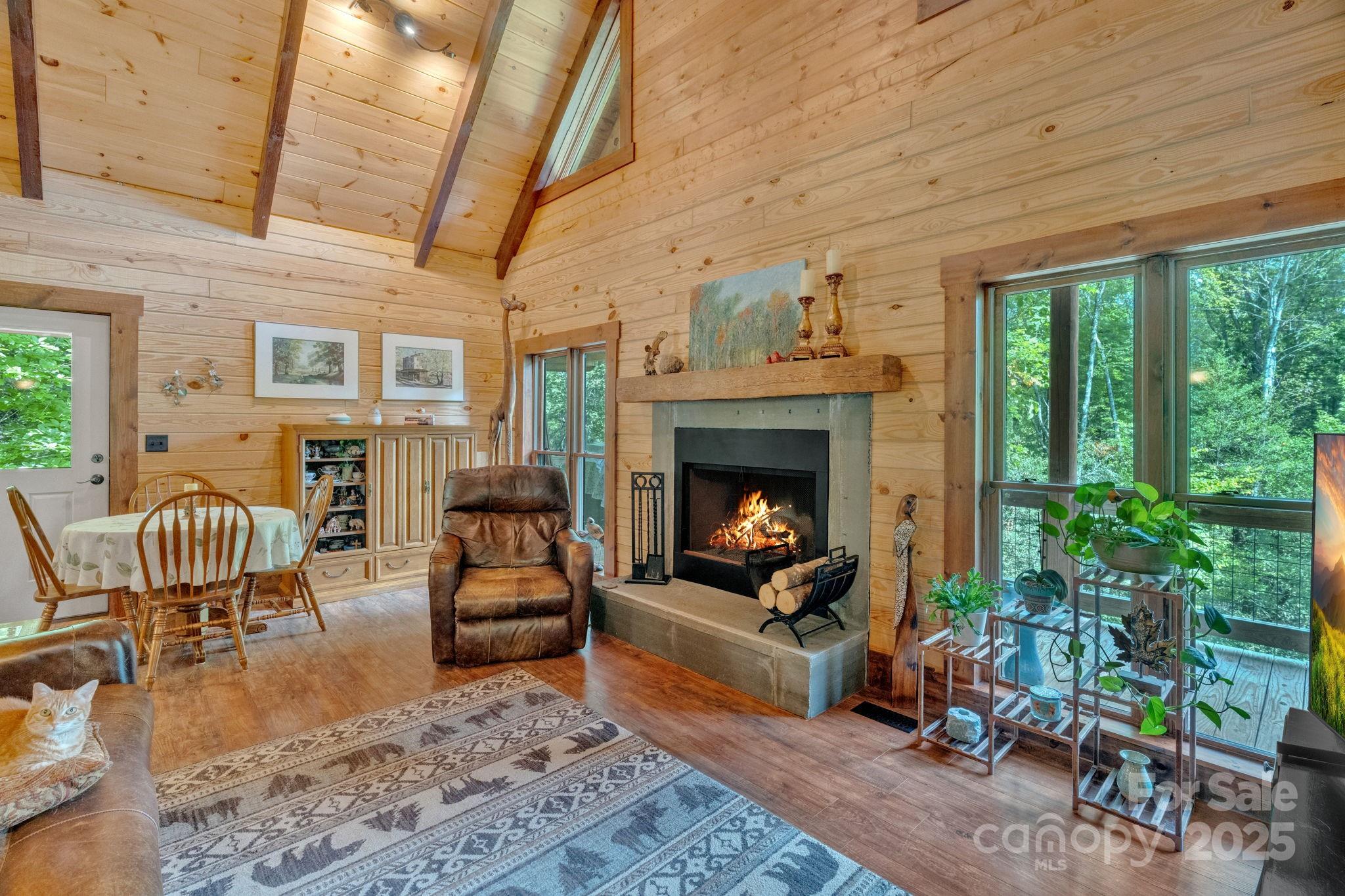 103 Mountain Laurel Road Pisgah Forest, NC 28768 - Photo 7 of 40 a living room with furniture and a fireplace