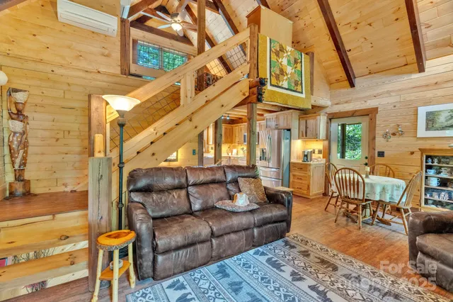 a view of a patio with couches chairs and wooden floor