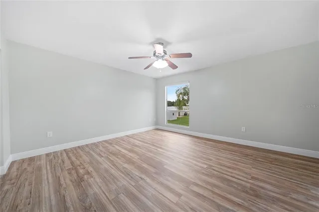 wooden floor in an empty room with a window