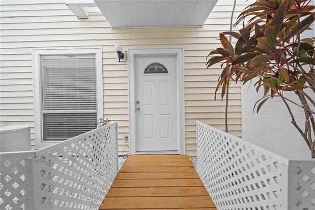 a view of a balcony with wooden floor and fence