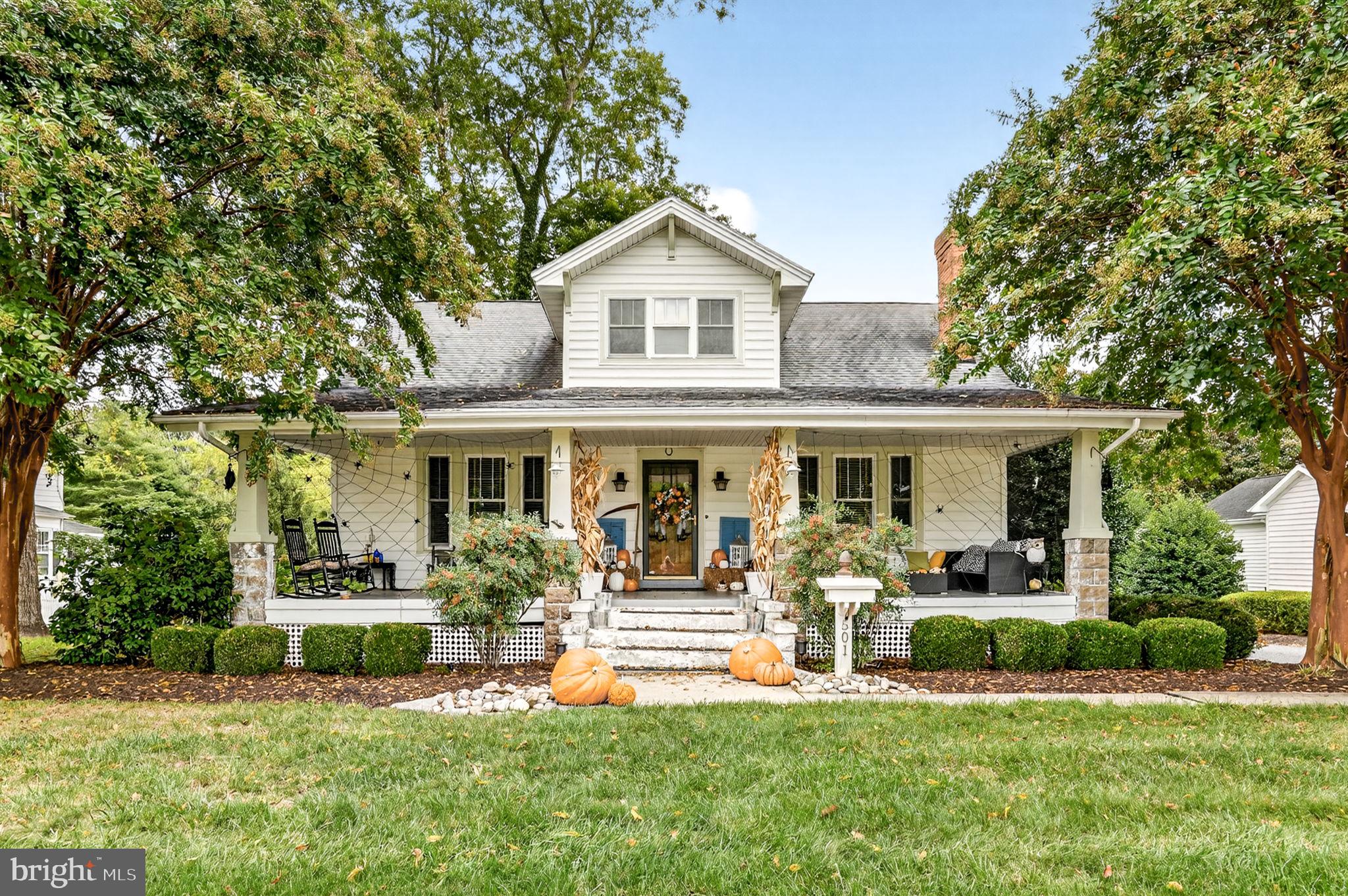 a front view of a house with a yard and porch