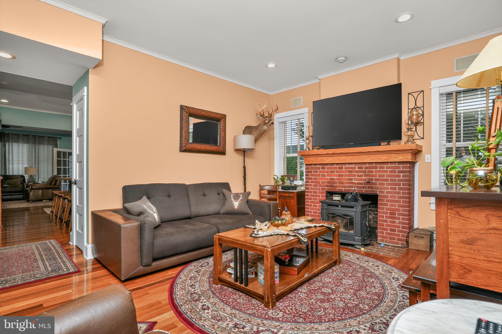 501 South Main Street Berlin, MD 21811 - Photo 12 of 75 a living room with furniture a flat screen tv and a fireplace