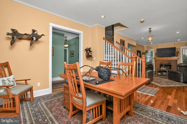 a kitchen with stainless steel appliances granite countertop a stove a sink dishwasher and cabinets with wooden floor