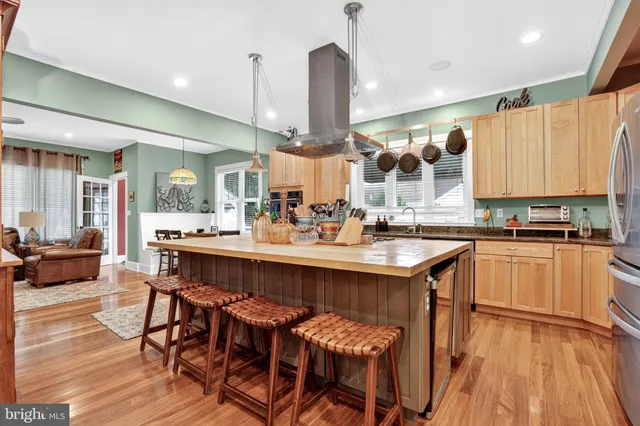 a view of a dining room with furniture wooden floor and chandelier