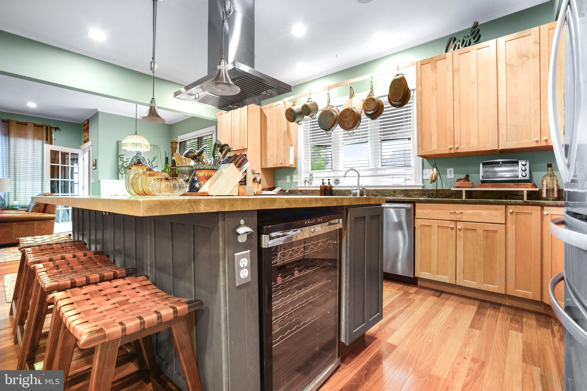 501 South Main Street Berlin, MD 21811 - Photo 18 of 75 a kitchen with stainless steel appliances granite countertop a sink and wooden cabinets