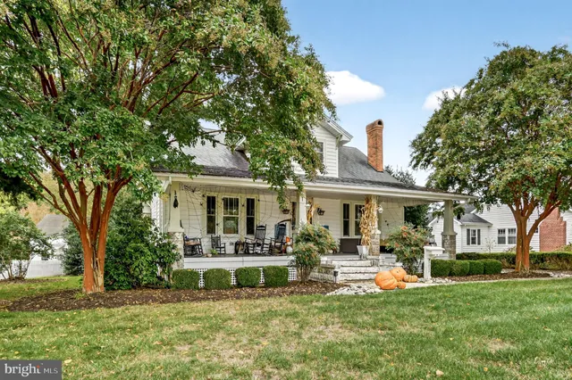a view of a house with a yard and sitting area