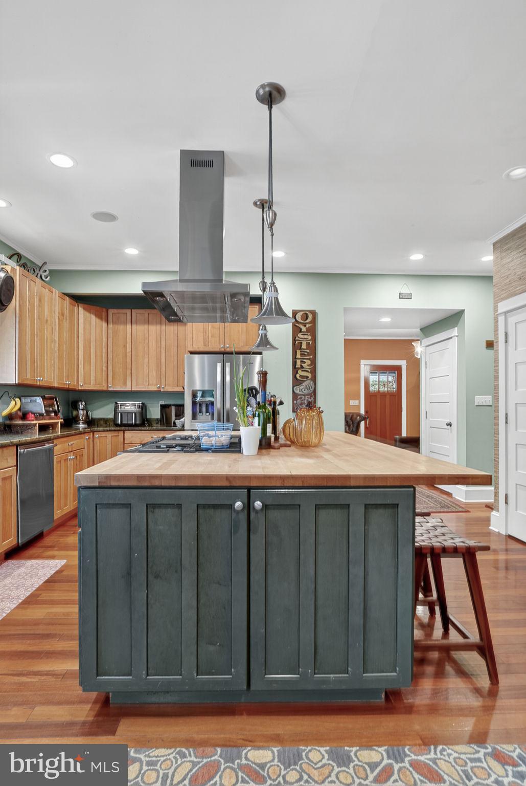501 South Main Street Berlin, MD 21811 - Photo 21 of 75 a kitchen with stainless steel appliances granite countertop a stove a sink dishwasher and cabinets with wooden floor