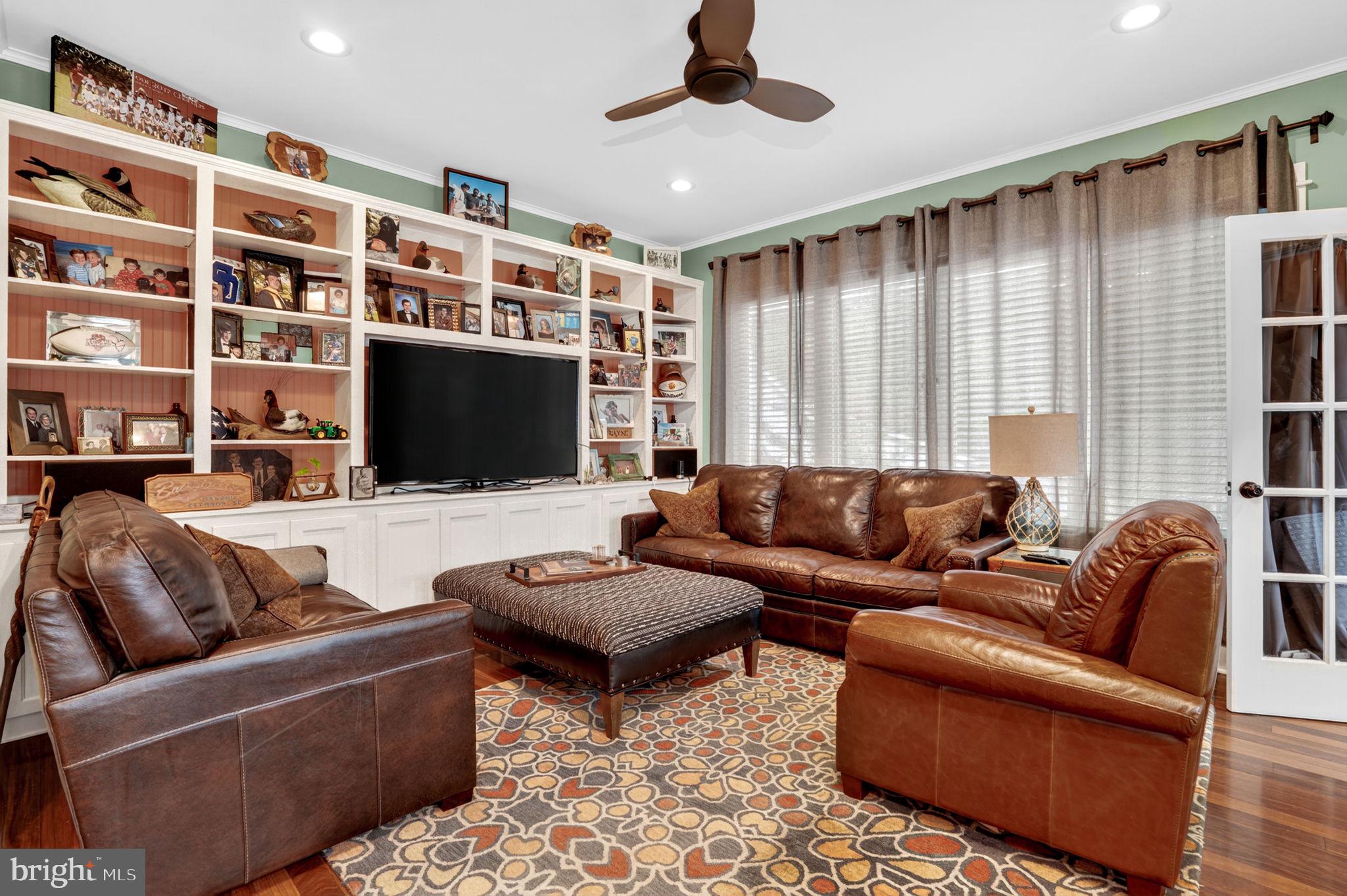 501 South Main Street Berlin, MD 21811 - Photo 25 of 75 a living room with furniture and a flat screen tv