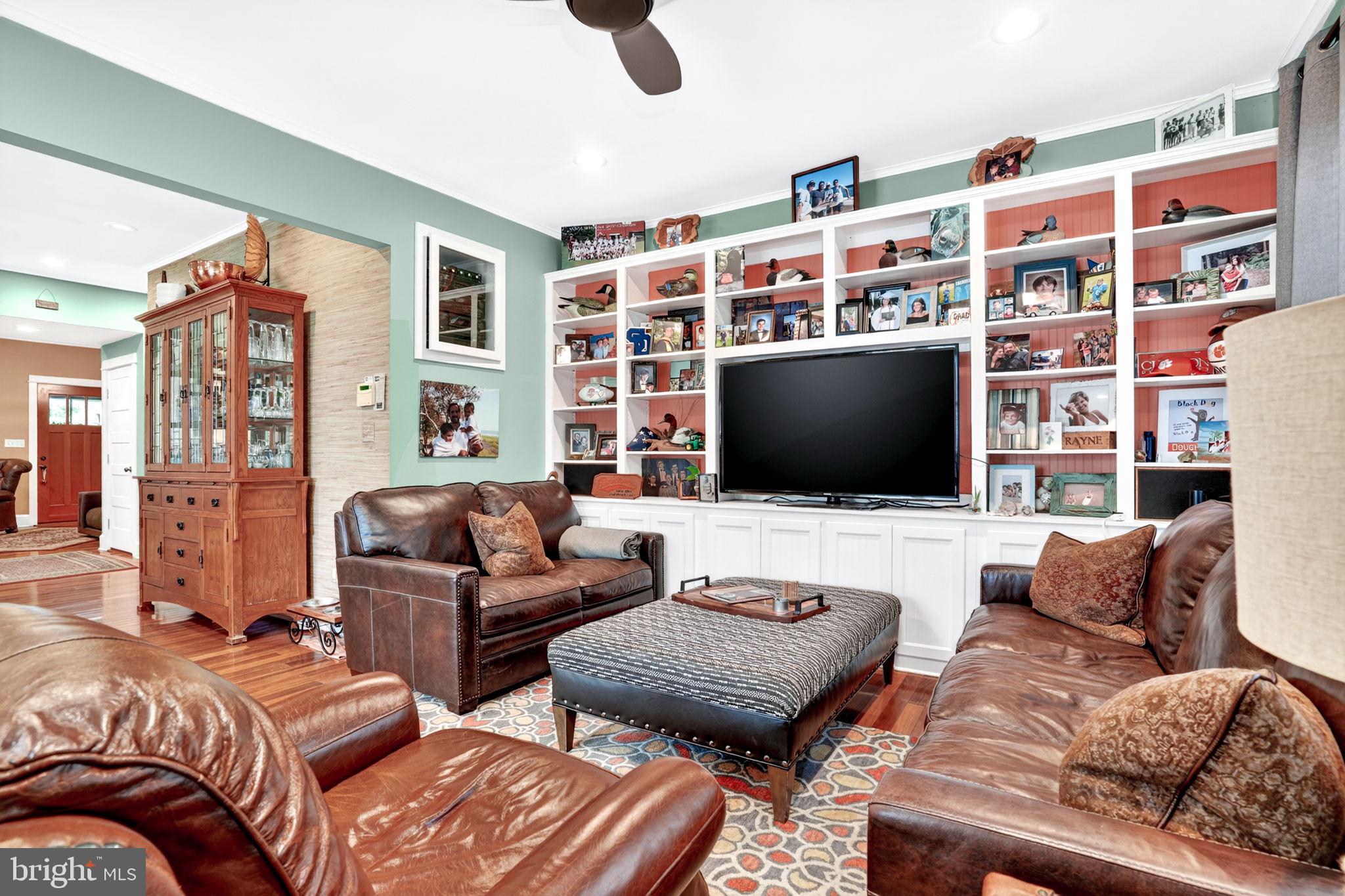 501 South Main Street Berlin, MD 21811 - Photo 27 of 75 a living room with furniture and a flat screen tv