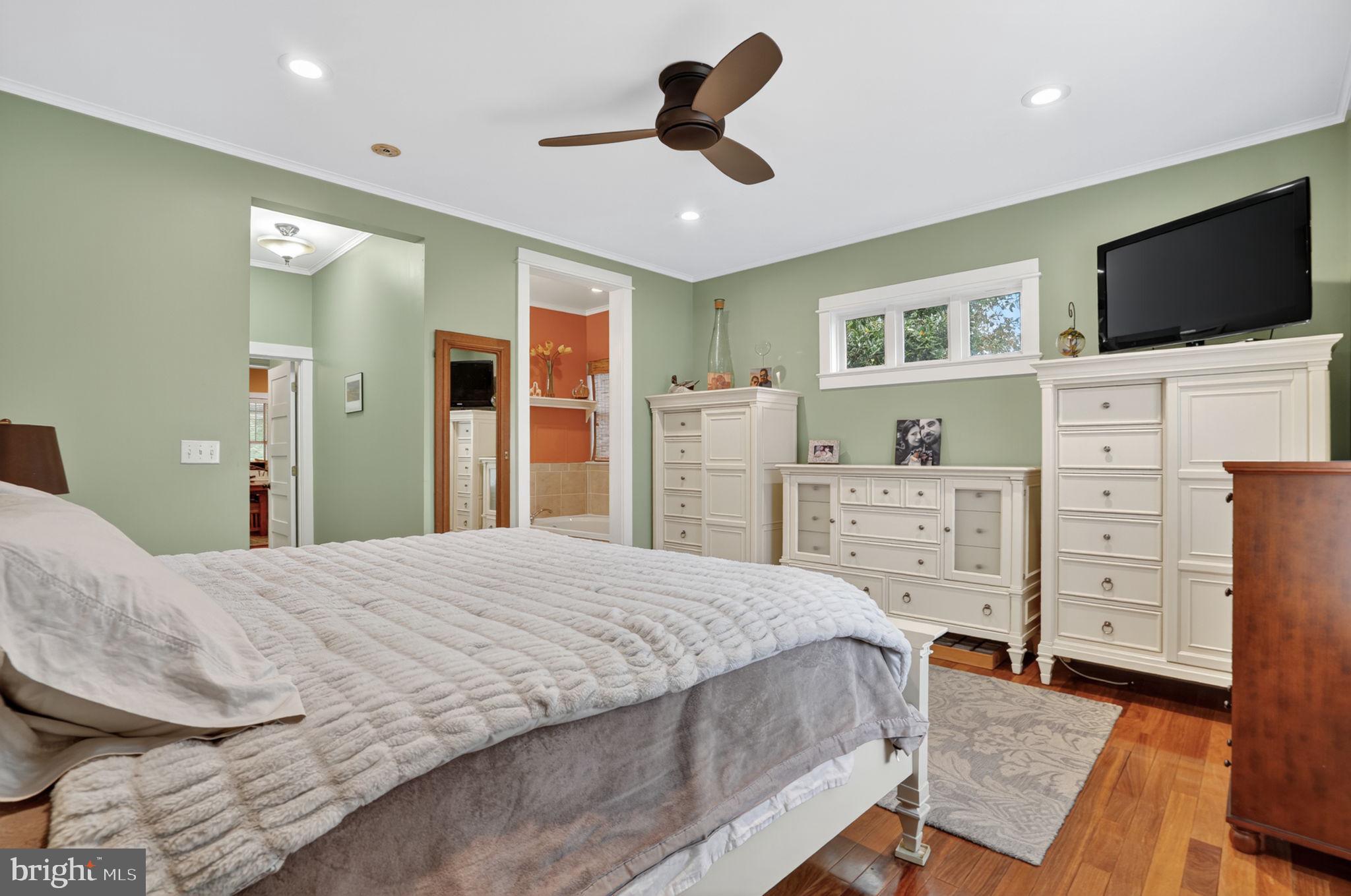 501 South Main Street Berlin, MD 21811 - Photo 37 of 75 a bedroom with a bed and flat screen tv